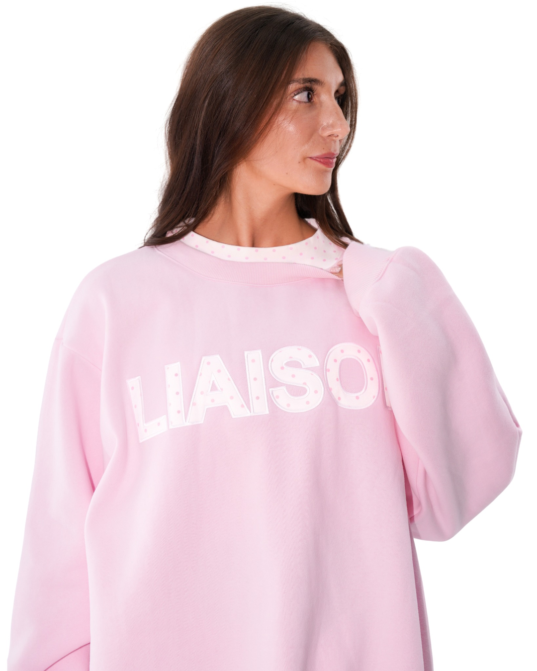 front view of model wearing the layered mockneck in soft pink and white polka dots